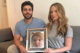 Rachael and Jonny Casella hold a photo of their late daughter Mackenzie