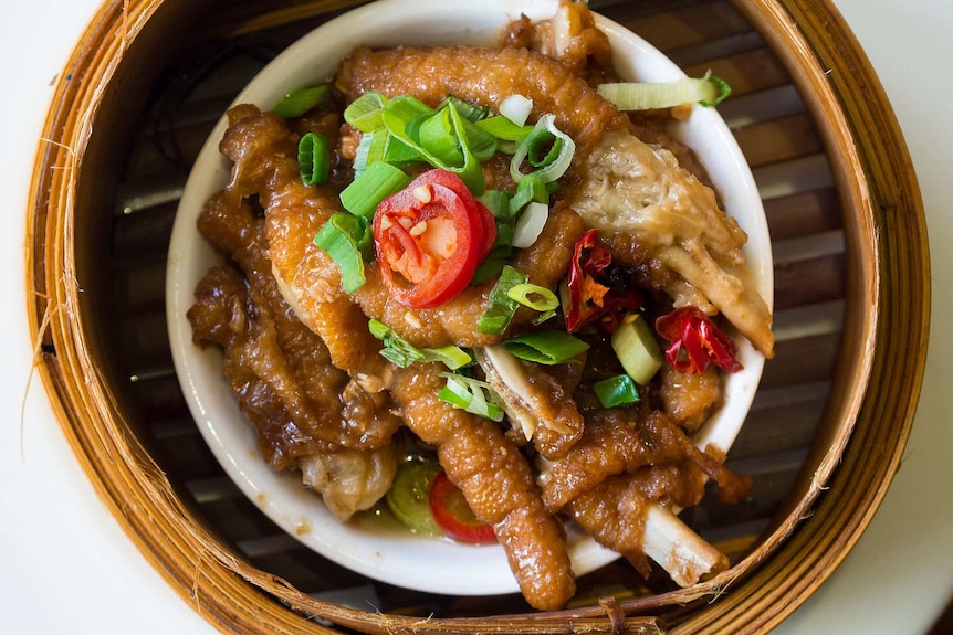 Chicken feet in a bamboo steamer