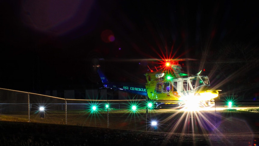 The RACQ CQ Rescue Helicopter at night with all its lights on