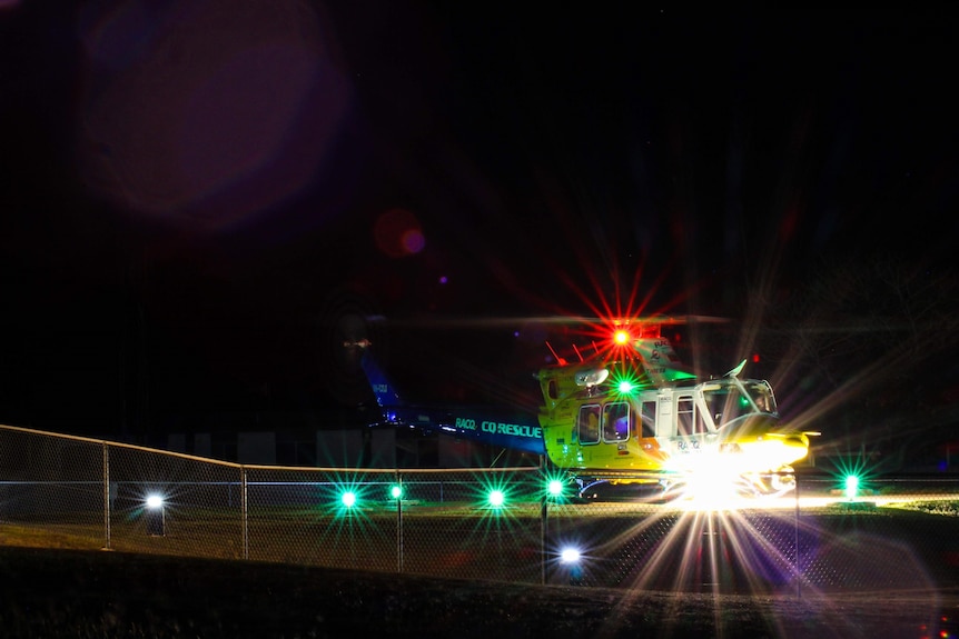 The RACQ CQ Rescue Helicopter at night with all its lights on
