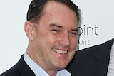 Upper body photo of real estate agency founder John McGrath, smiling