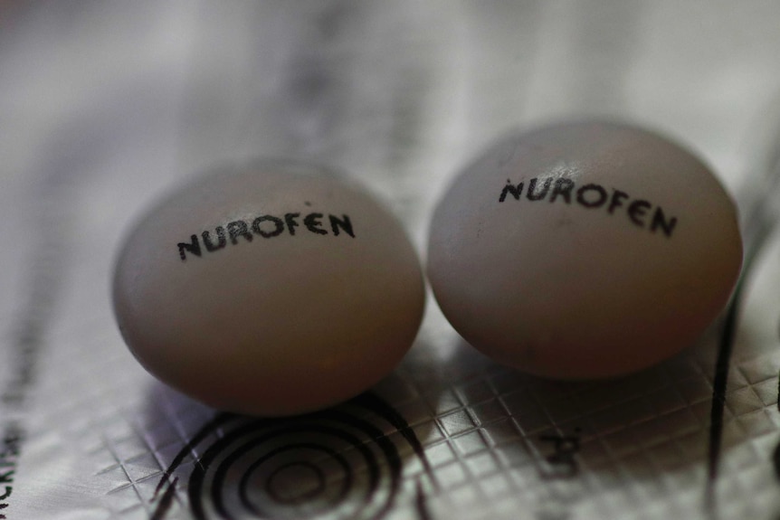 A close up of two Nurofen pills.
