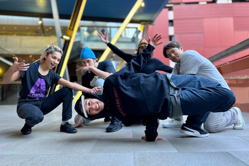 A breakdancer poses with their crew 