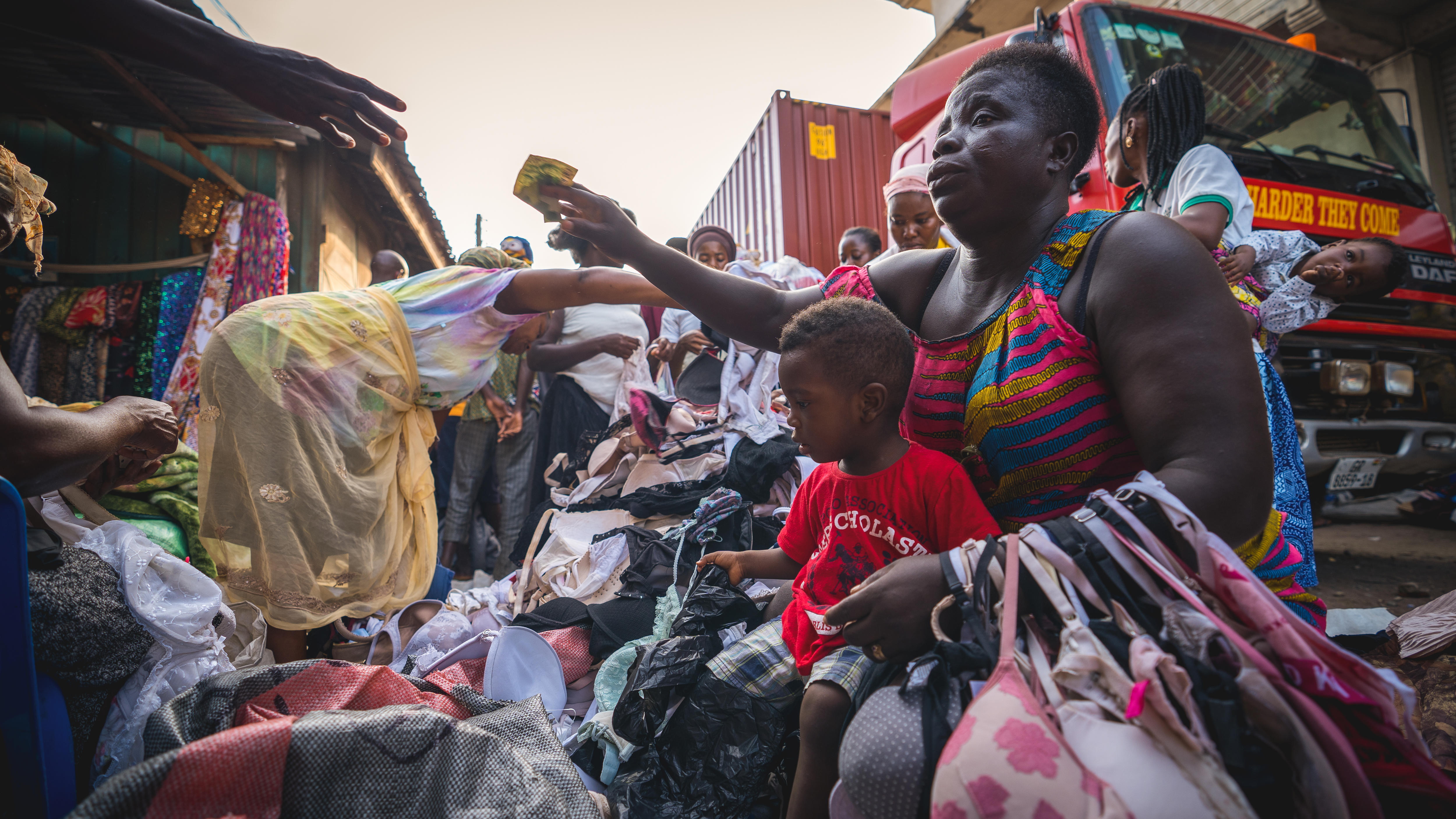 A woman buys clothes in Kantamanto Market, Accra.