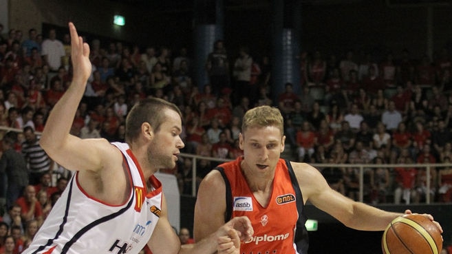 Outmuscled...Perth's big front court, led by Shawn Redhage (r), was too much for the Hawks.