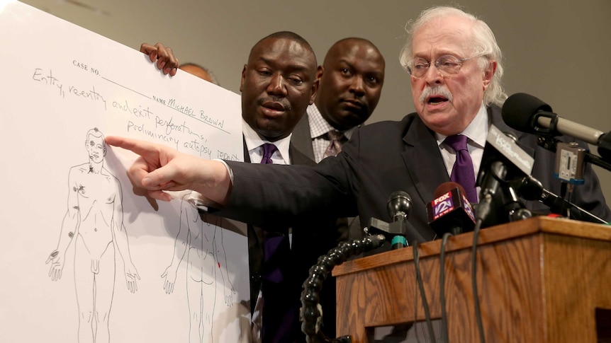 Dr Michael Baden points to autopsy diagram