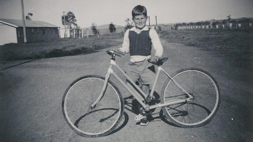 Old photo of boy with bicycle
