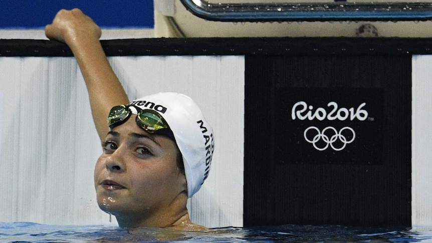 Refugee Olympic Team's Yusra Mardini holds onto the edge of the pool after the women's 100m Butterfly heat.