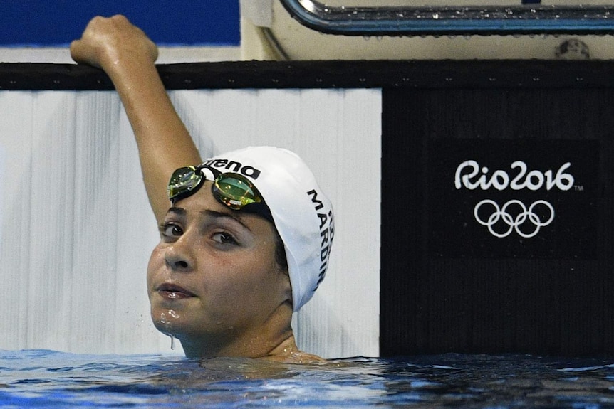 Refugee Olympic Team's Yusra Mardini holds onto the edge of the pool after the women's 100m Butterfly heat.