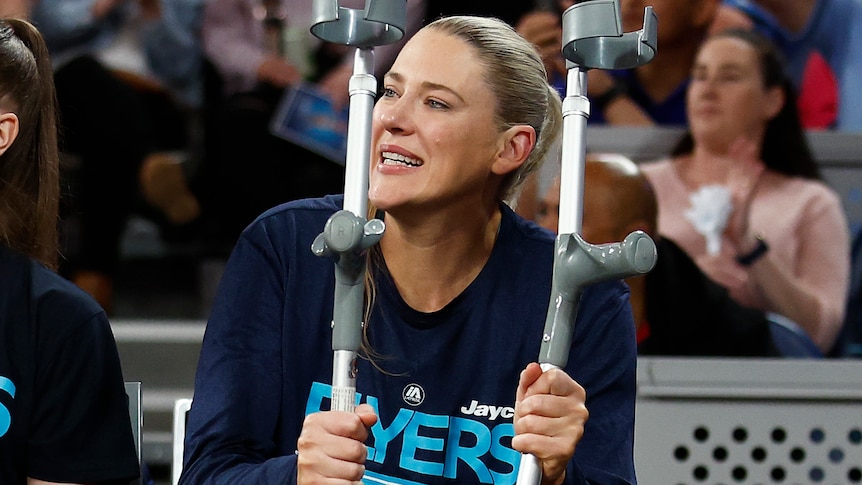 Lauren Jackson holds a pair of crutches