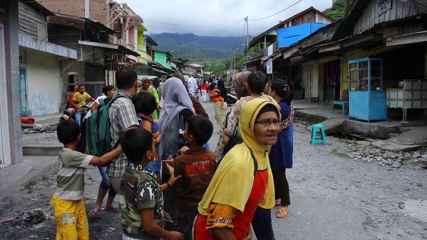 Achenese residents stand outside their homes after an earthquake shook Indonesia.