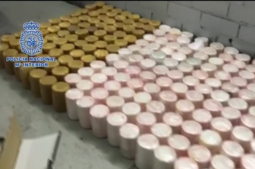 Dozens of cylindrical parcels containing cocaine which were hidden in pineapples lined up in Lisbon.