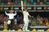 Umpire Richard Illingworth signals six as Joe Burns celebrates a century against New Zealand.
