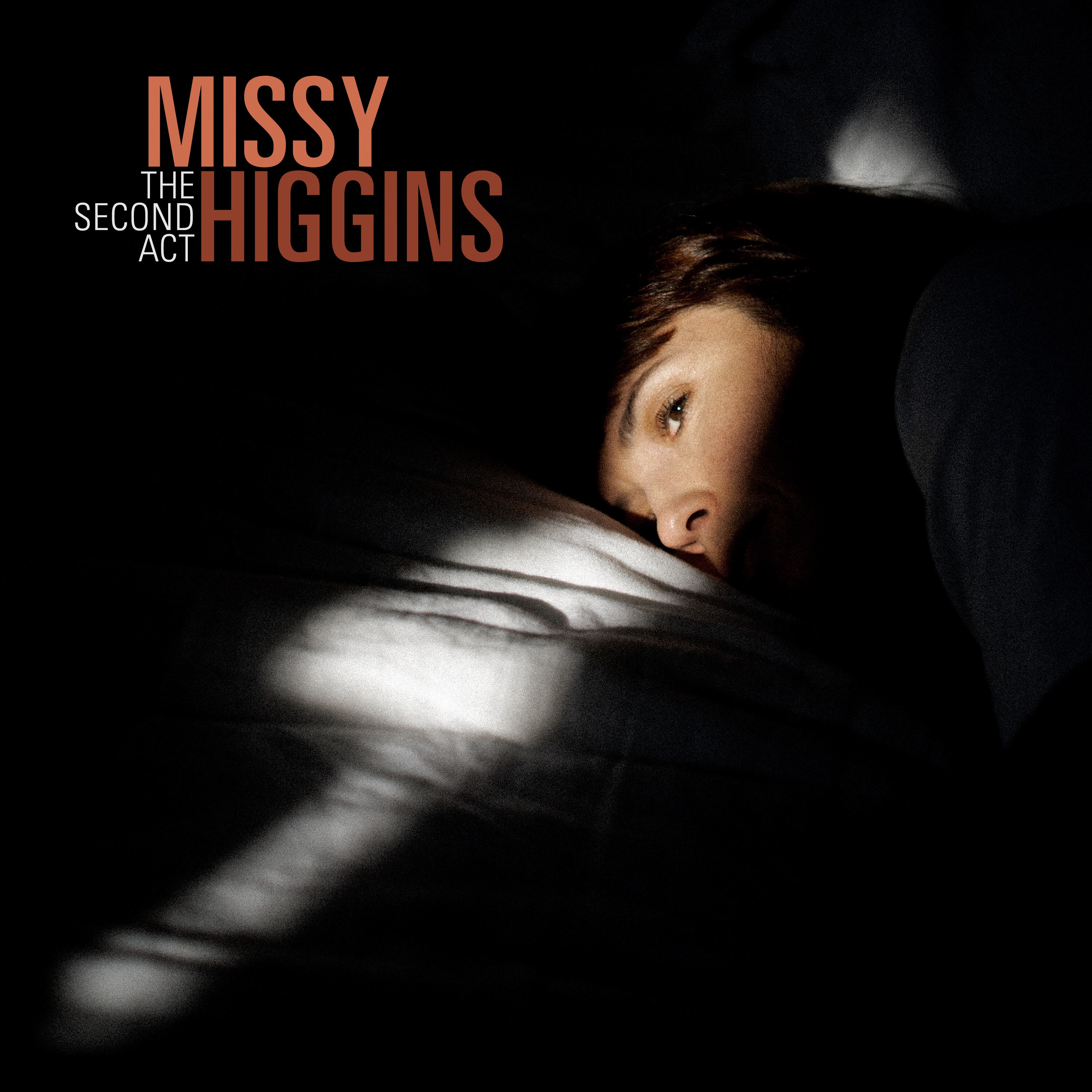 Missy Higgins lies in darkness, a beam of light lies across her eyes and white pillow. Text reads: Missy Higgins The Second Act