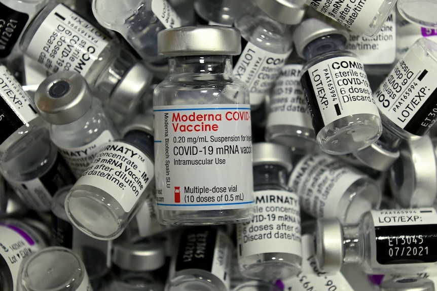 Empty vials of different vaccines by Moderna, Pfizer-BioNTech and AstraZeneca. 