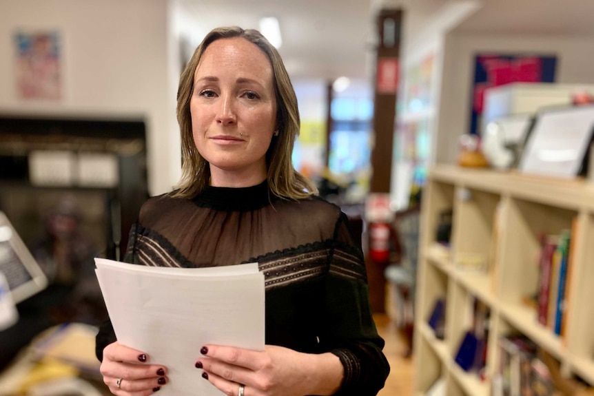 a woman holding documents