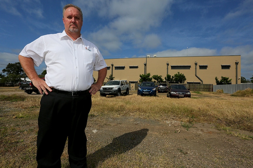 A man stands next to an empty block near the Indigenous Wellbeing Centre building in Bundaberg.