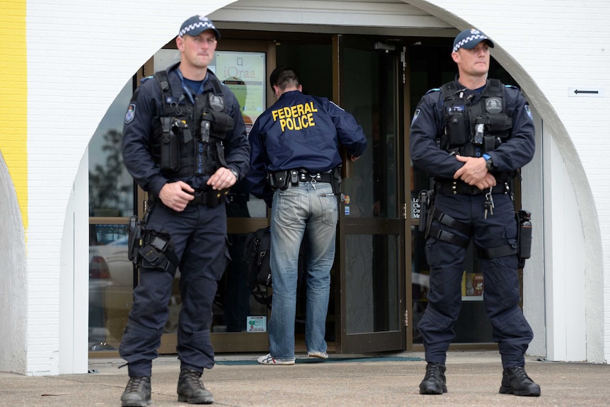 Queensland police and AFP officers outside the iQraa Islamic centre at Underwood.