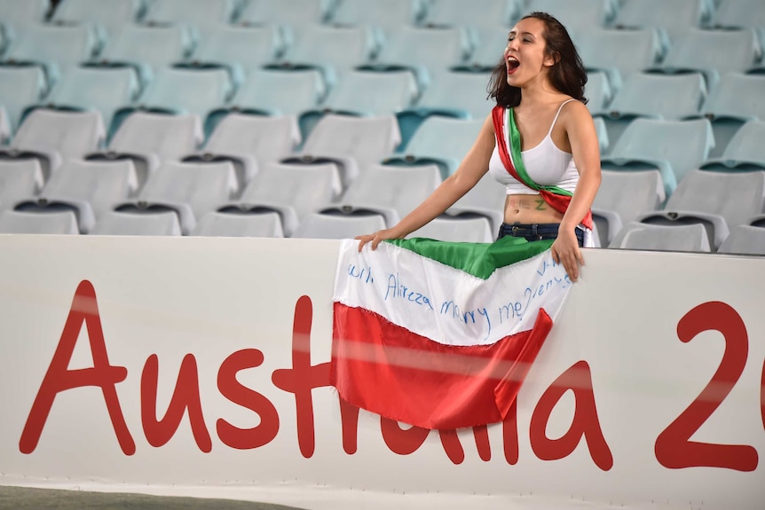 A fan of Iran cheers during their game against Qatar in the AFC Asian Cup