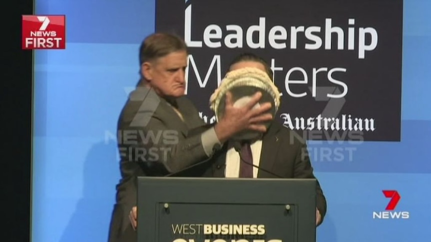 Qantas CEO Alan Joyce hit in the face with a pie