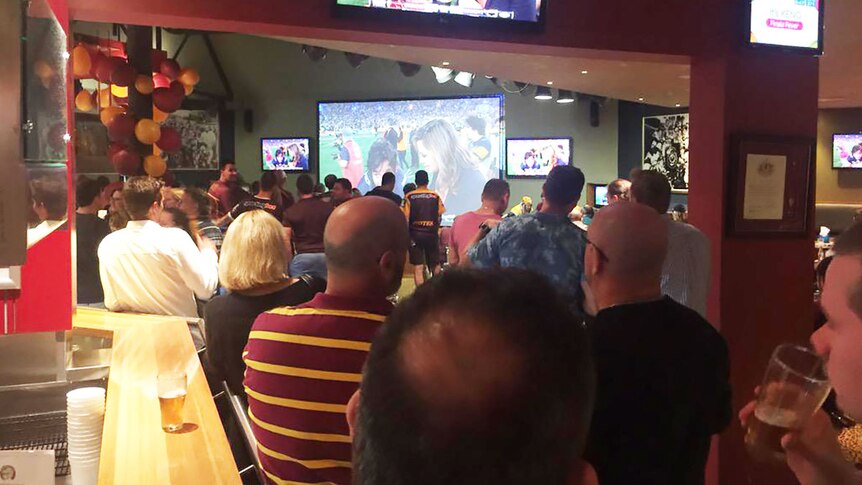 Fans at the Brisbane Broncos Leagues Club acknowledge Johnathan Thurston's efforts after he led the Cowboys to victory.