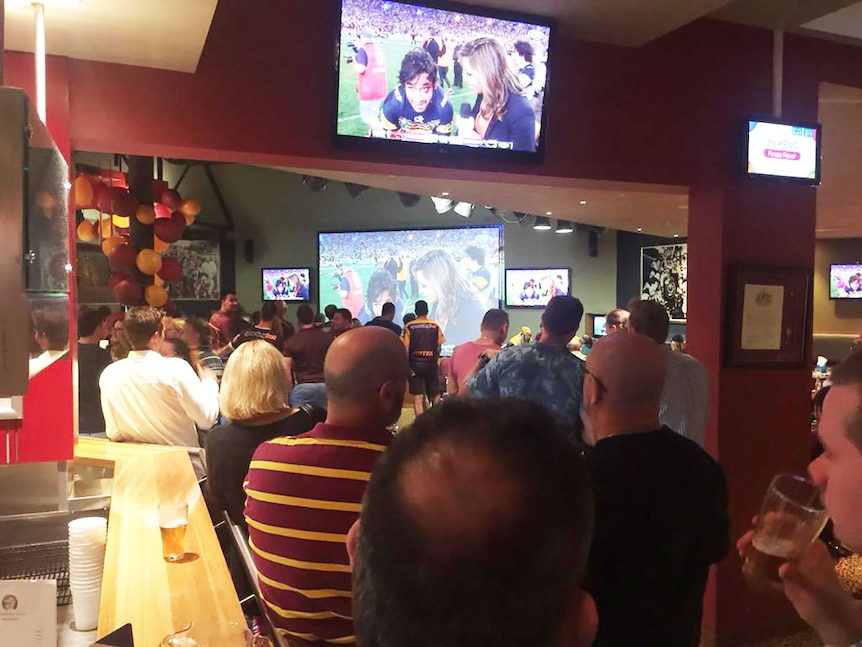 Fans at the Brisbane Broncos Leagues Club acknowledge Johnathan Thurston's efforts after he led the Cowboys to victory.
