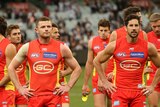 The Gold Coast Suns walking from the field.