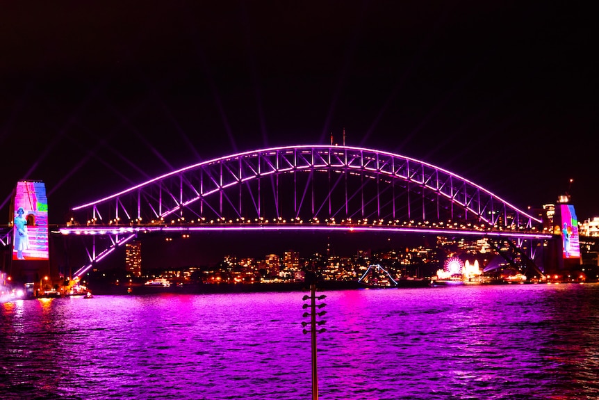 A bridge lit up in purple 