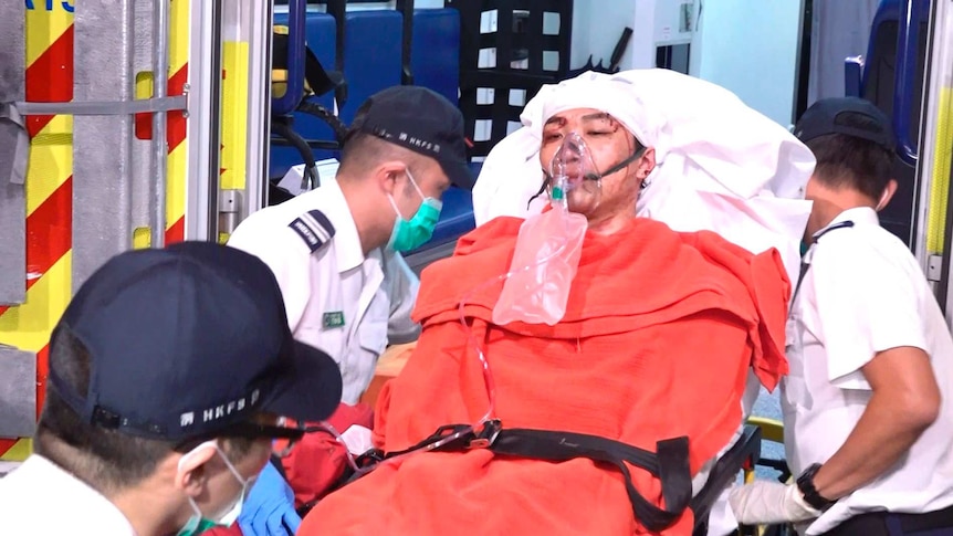 Civil Human Rights Front convenor Jimmy Sham, in a stretcher with a bloodied face, is carried to hospital in Hong Kong.