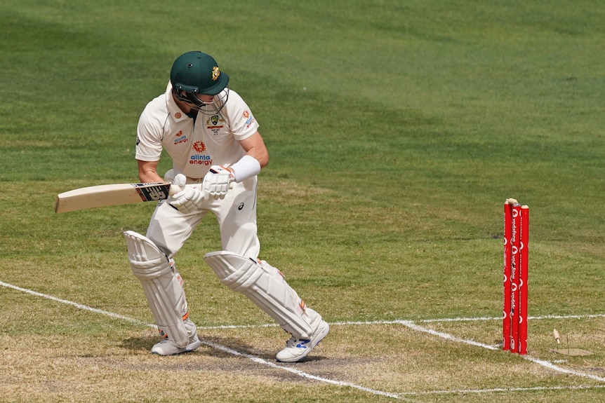 Australia batsman Steve Smith looks back as a bail falls off the stumps during a Test against India at the MCG.