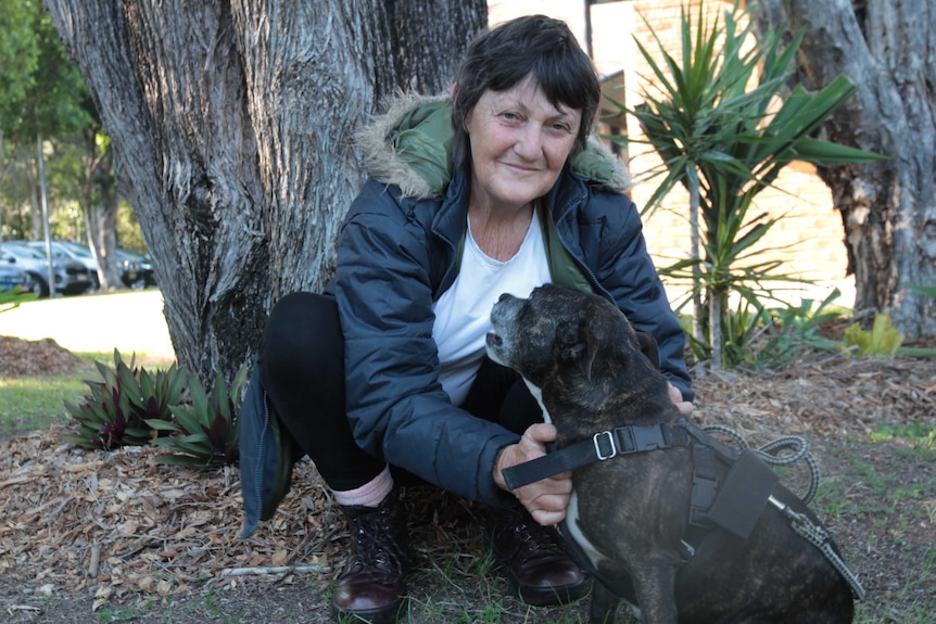 A woman with a small staffie