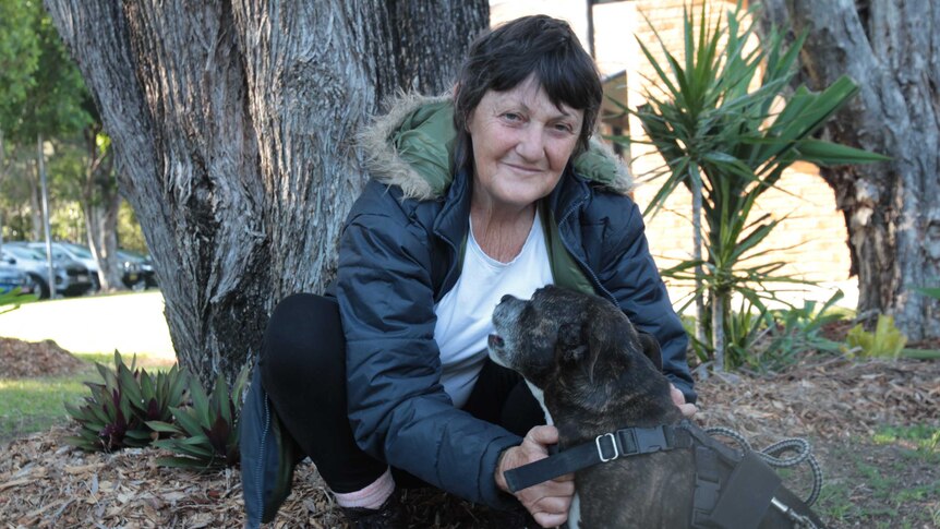 A woman with a small staffie
