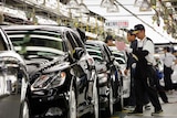 Workers at Toyota inspect newly assembled LEXUS cars