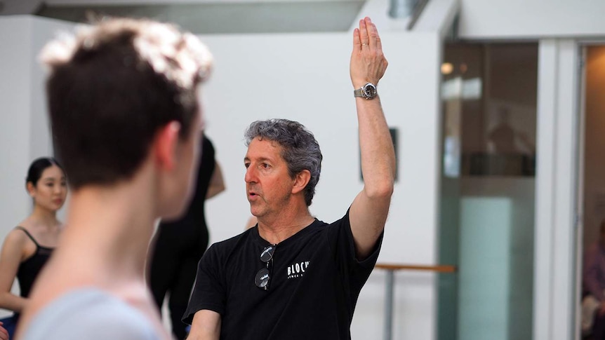 A male ballet teacher demonstrating a move.