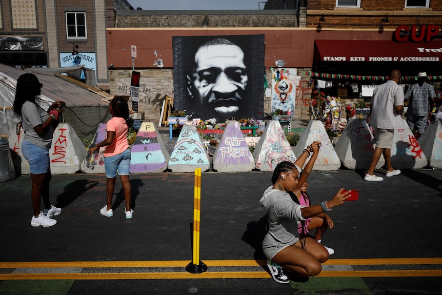 People mill around George Floyd square in Minneapolis to commemorate Juneteeth and the end of slavery in Texas