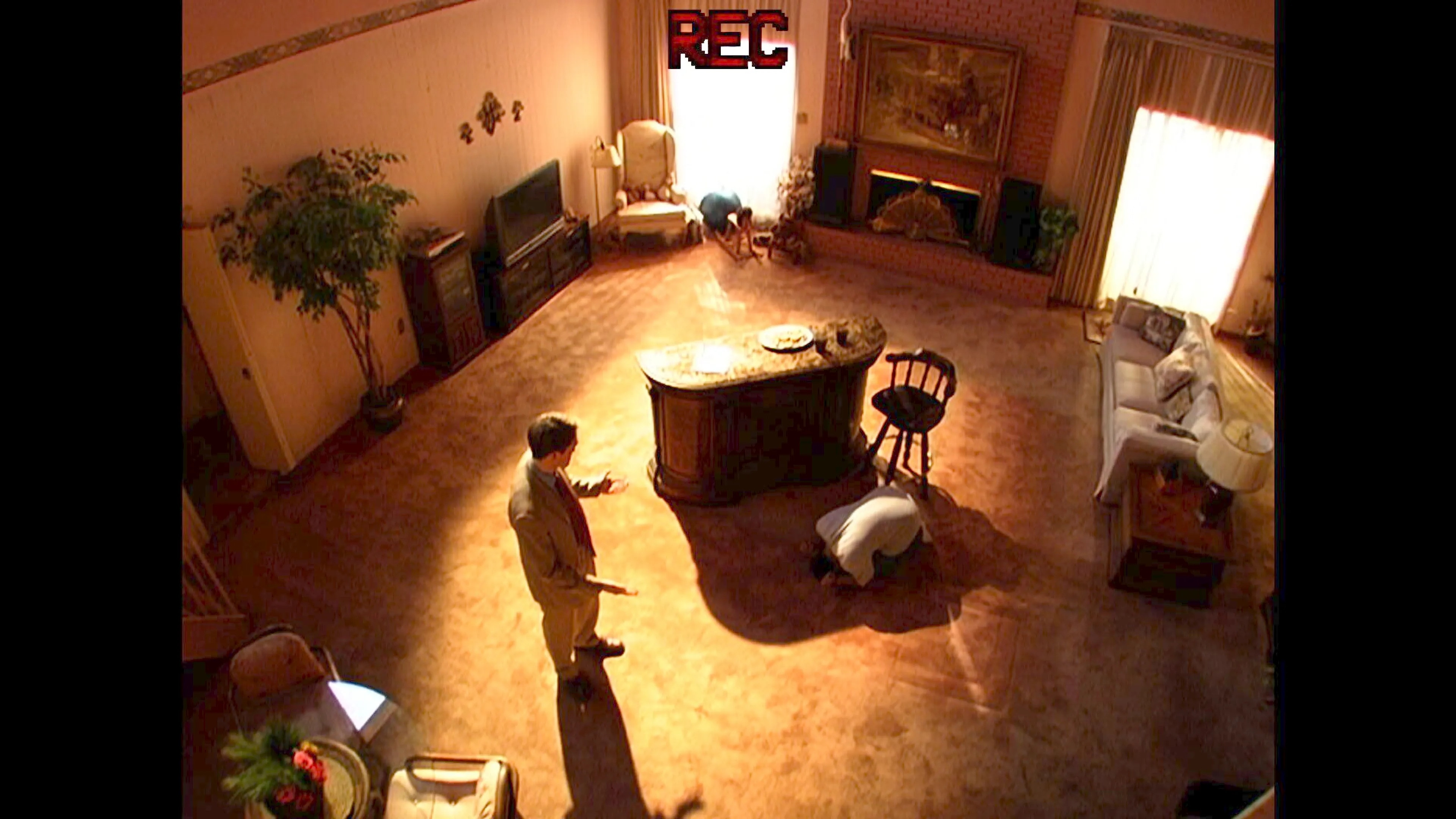 Two men stand in a lounge room
