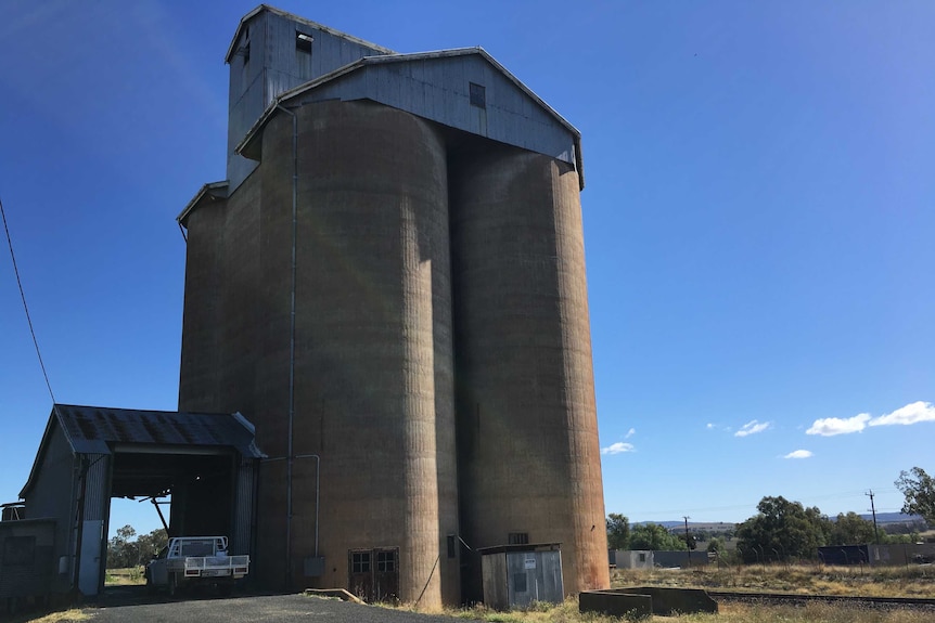 A grain silo beside rail tracks in country australia