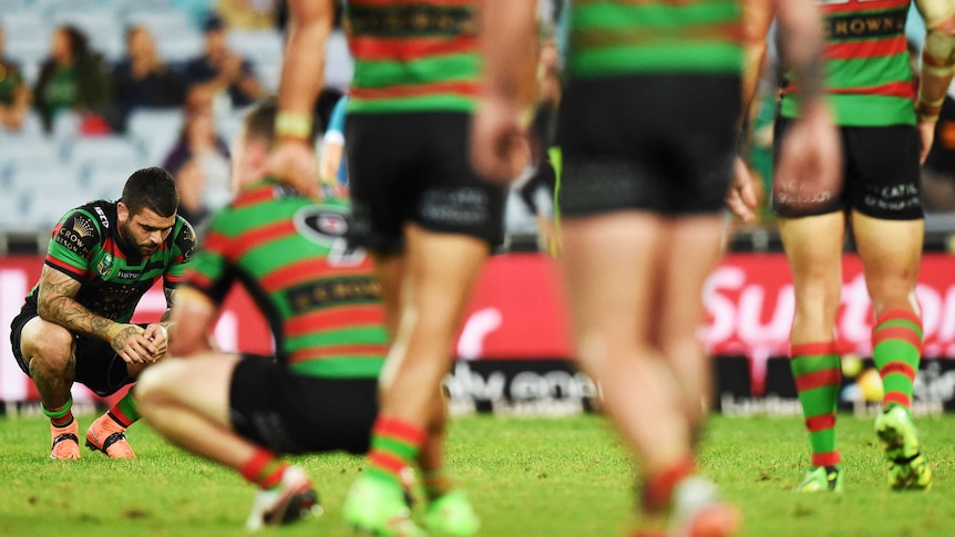 A dejected Adam Reynolds (far L) and team-mates after South Sydney's loss to Wests Tigers.