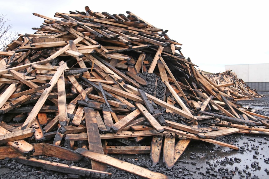 Pile of charred timber at the Orana factory after a fire.