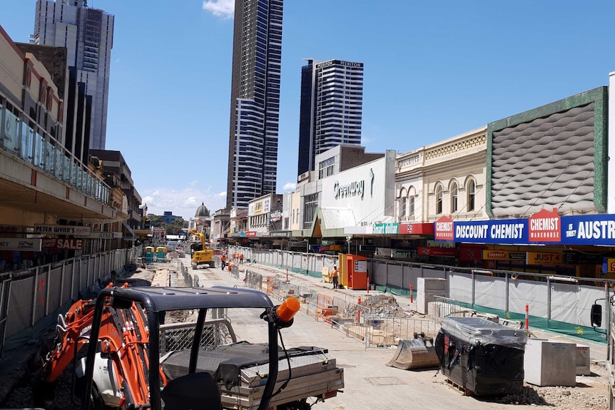 Construction takes place along a street.