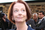 Julia Gillard leaves a press conference in Adelaide