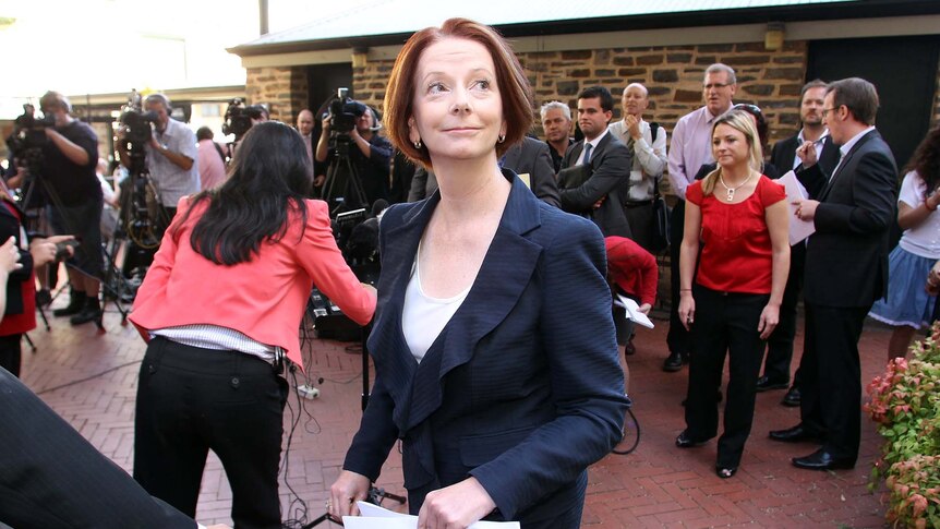 Julia Gillard leaves a press conference in Adelaide