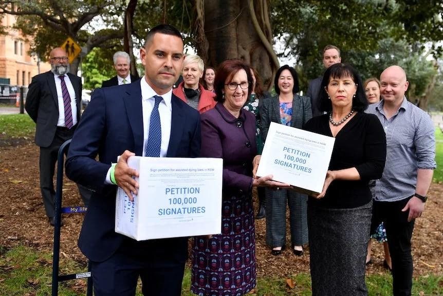 a group of eleven people with three of them holding boxes