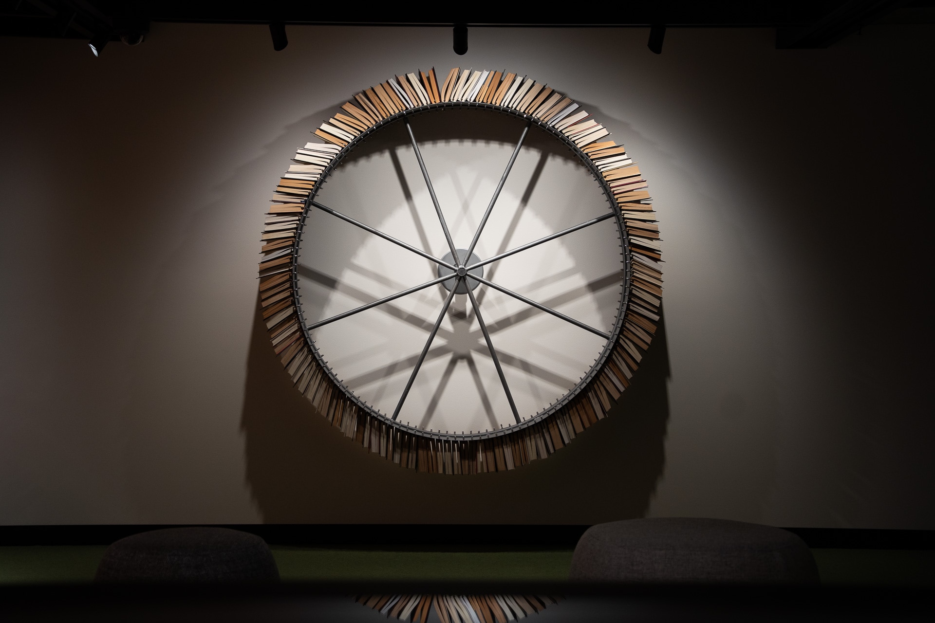 Books spinning around on a wheel, which is erected to a wall.