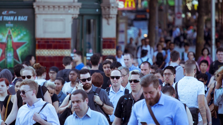Pedestrians cross at Flinders Street