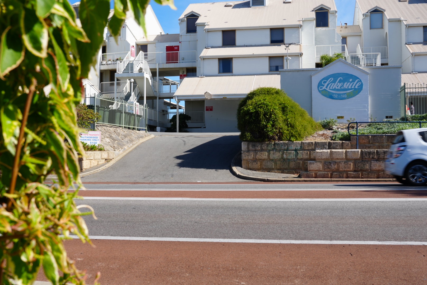 A group of holiday villas with a short drive way leading up to them.