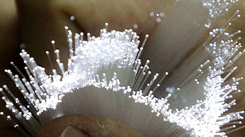 A worker holds fibre optic cable