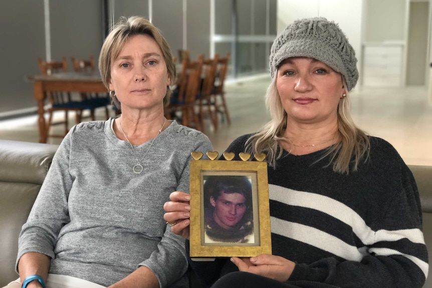 Paula Bunting and Starry Jansen with a photo of their brother Mark Jansen
