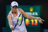 Ash Barty watches the ball as she plays a backhand return at the Australian Open.