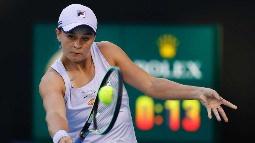 Ash Barty watches the ball as she plays a backhand return at the Australian Open.